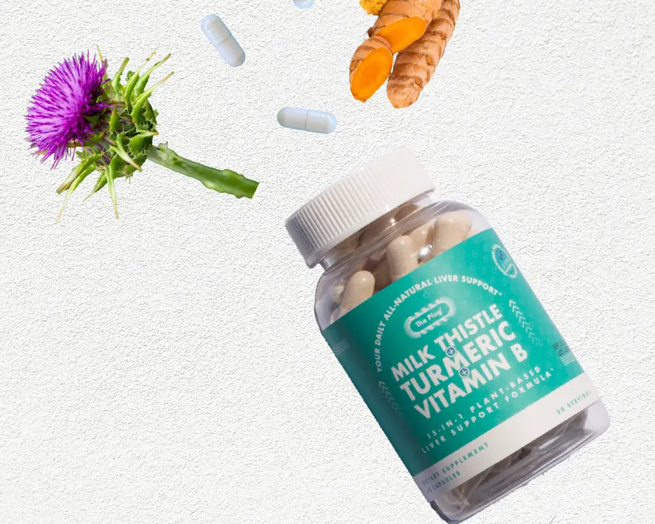 A purple milk thistle flower, a piece of fresh turmeric root and a bottle of The Plug Pills float against a white background.