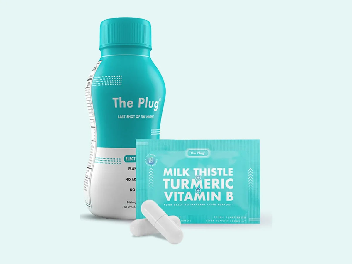 A bottle of The Plug Drink stands beside a packet of The Plug Pills and two white capsules on a pale teal background.