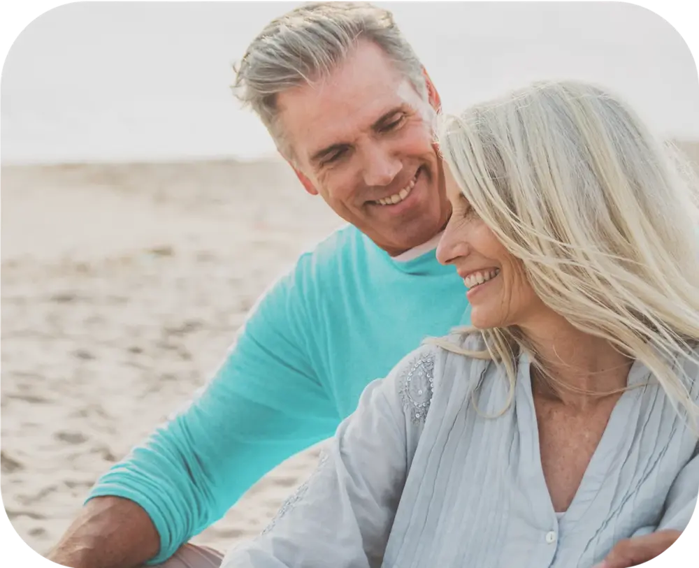 Smiling older couple enjoying time together on the beach
