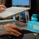 The Plug liver support drink bottle and Milk Thistle Turmeric Vitamin B pill boxes on a desk next to a laptop