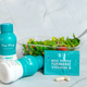 The Plug liver support drink bottle, Milk Thistle Turmeric Vitamin B pills, and a fresh salad