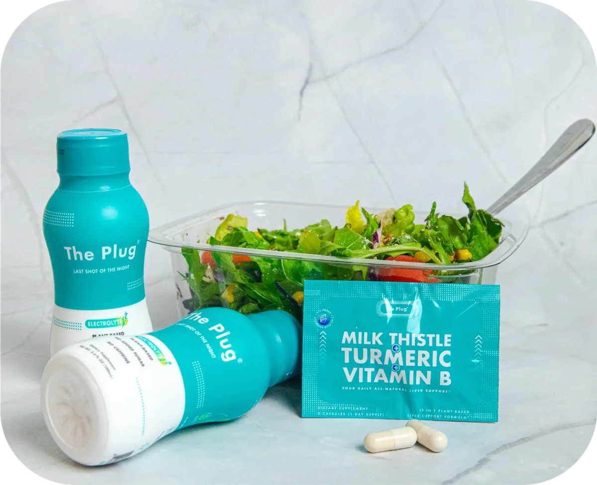 The Plug liver support drink bottle, Milk Thistle Turmeric Vitamin B pills, and a fresh salad