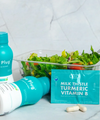 The Plug liver support drink bottle, Milk Thistle Turmeric Vitamin B pills, and a fresh salad