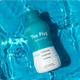 The Plug liver drink bottle, Last Shot of the Night flavor, floating in blue pool water