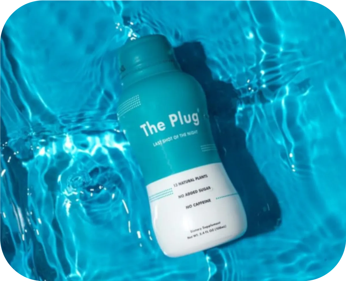The Plug natural liver detox drink bottle floating in blue pool water