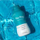 The Plug natural liver detox drink bottle floating in blue pool water