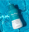 The Plug natural liver detox drink bottle floating in blue pool water