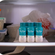 Three bottles of The Plug liver health drink stored in a refrigerator