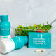 Two bottles of The Plug liver drink next to a fresh salad and milk thistle turmeric vitamin B supplement pack