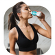 Woman in workout gear drinking The Plug hangover drink after exercising