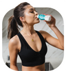 Woman in workout gear drinking The Plug hangover drink after exercising